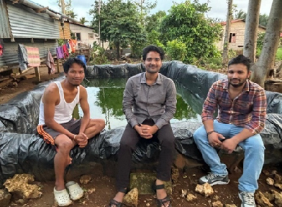 HDPE-lined rainwater harvesting pond storing collected rainwater in a rural Indian setting